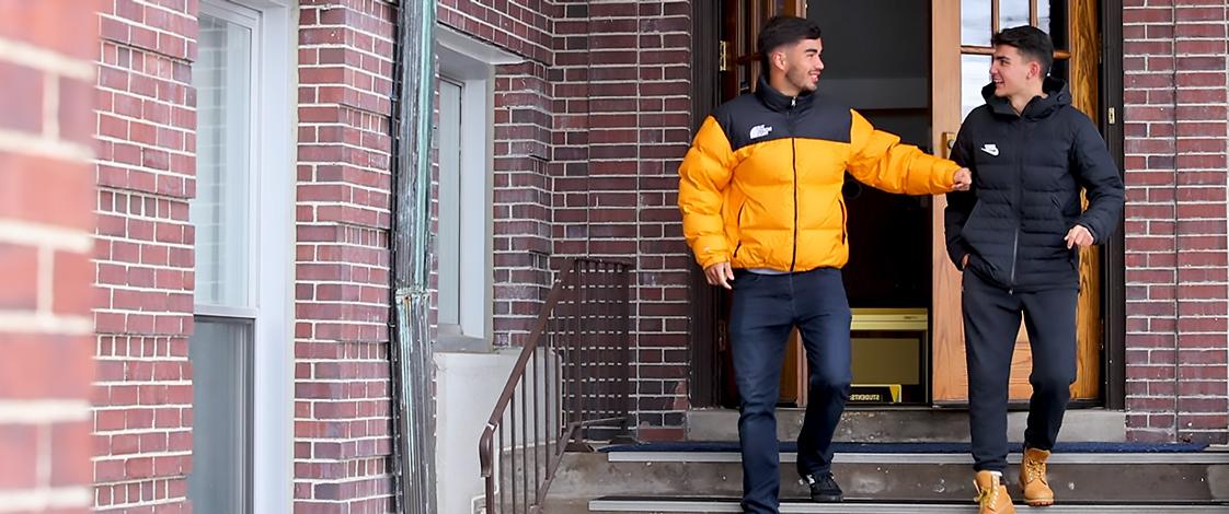 Two students talking outside of Warde Hall